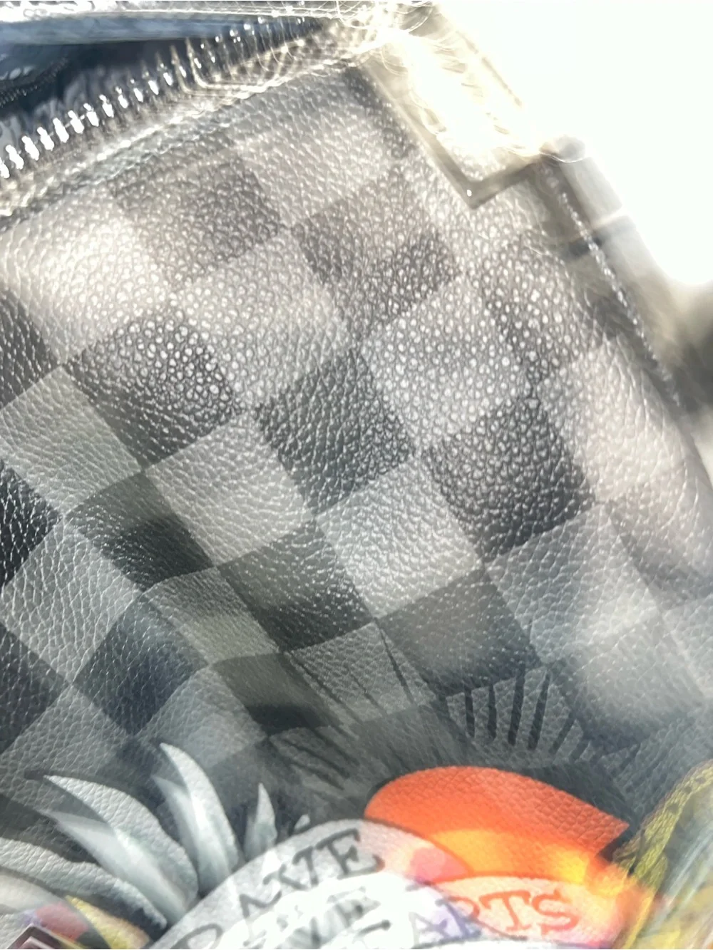 Ed Hardy duffel bag features a black and grey checkered pattern